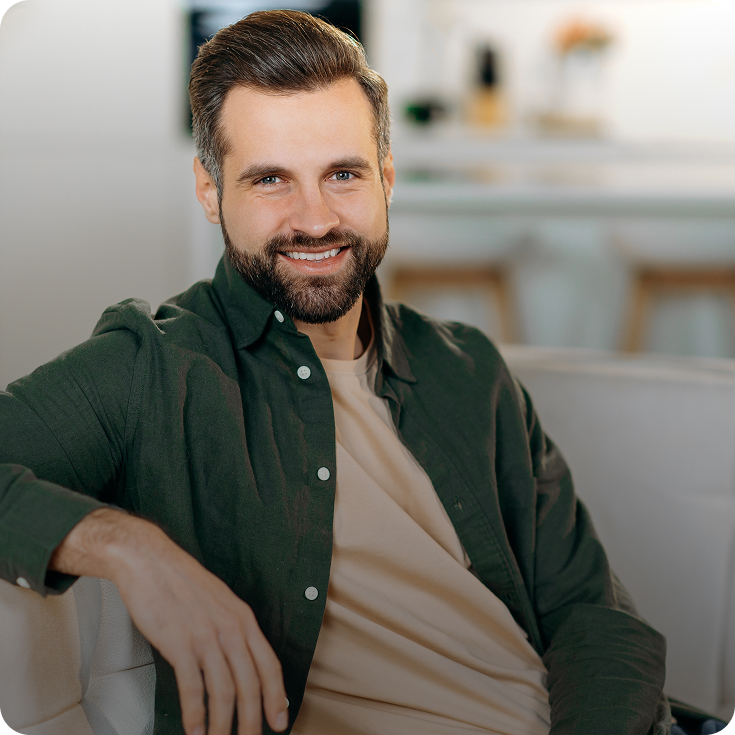 Smiling man sitting at home – online psychiatry in Ann Arbor, MI